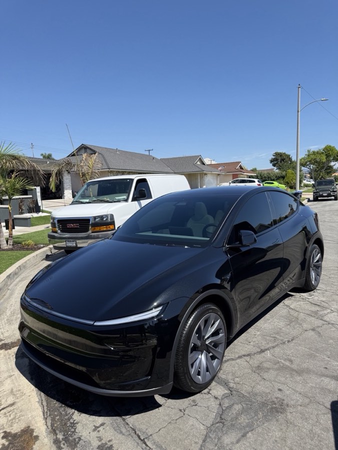 Black Tesla Model Y with deep gloss after paint correction